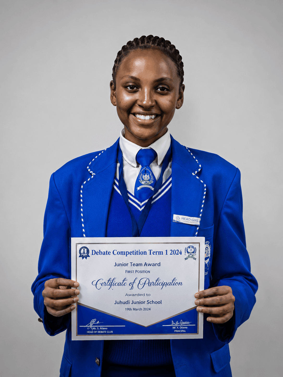 Learner in a blue blazer holding a school certificate